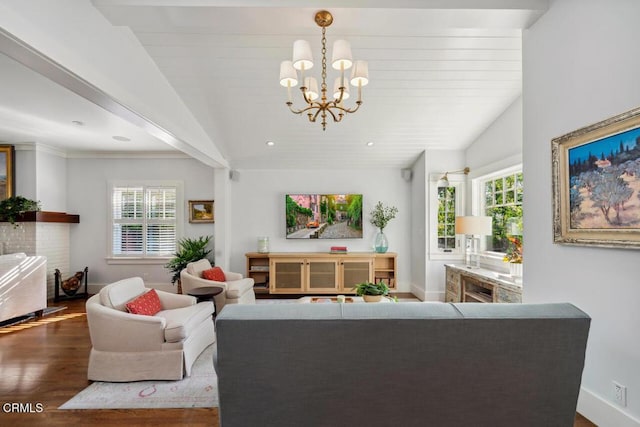 living room with plenty of natural light, dark hardwood / wood-style flooring, an inviting chandelier, and vaulted ceiling