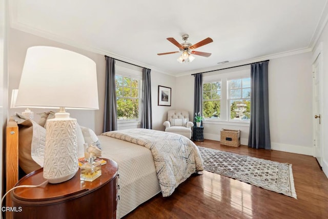 bedroom with ceiling fan, ornamental molding, and dark hardwood / wood-style flooring