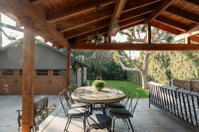 view of patio featuring an outdoor hangout area, a garage, and an outbuilding