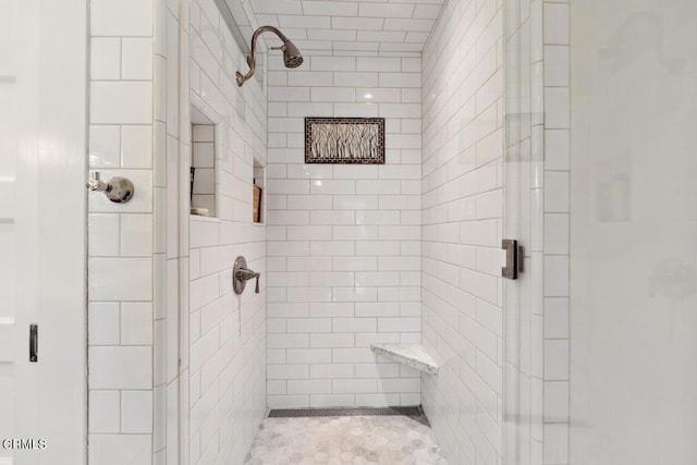 bathroom featuring a shower with door