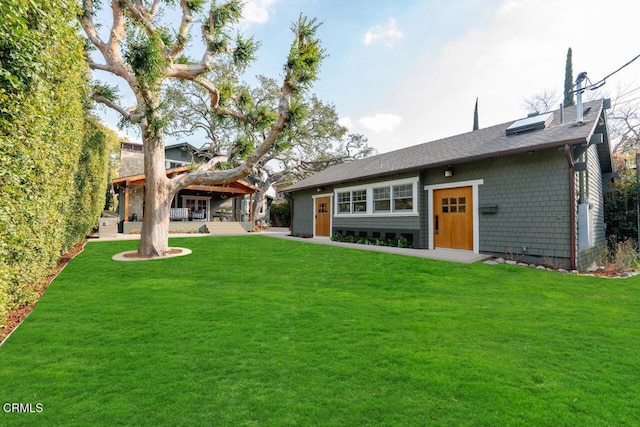 rear view of property with a yard