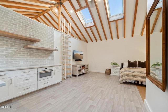 interior space featuring beam ceiling, light hardwood / wood-style flooring, white oven, high vaulted ceiling, and white cabinets