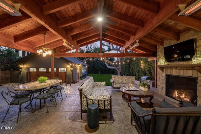 view of patio with a gazebo, an outbuilding, area for grilling, and an outdoor living space with a fireplace