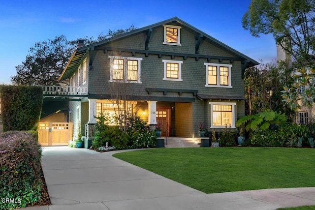 craftsman-style home featuring a garage, a carport, and a yard