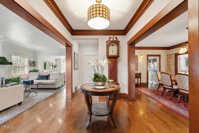 entryway featuring ornamental molding and hardwood / wood-style floors