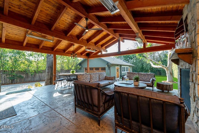 view of patio / terrace with an outbuilding, an outdoor hangout area, ceiling fan, and a garage