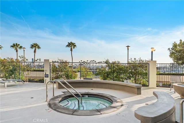 view of pool featuring a patio area and a community hot tub