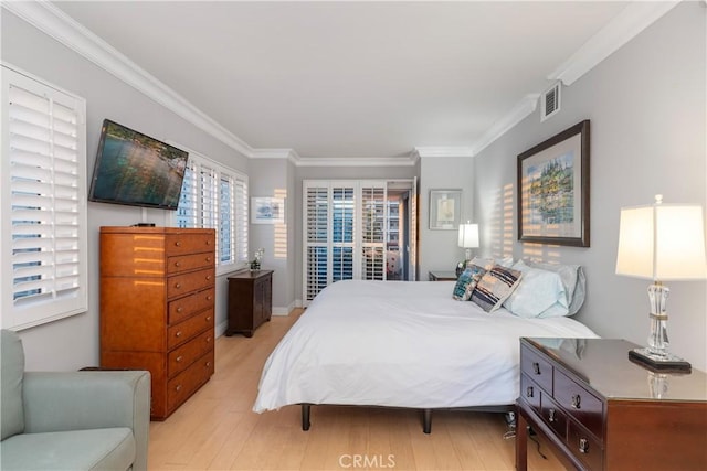 bedroom featuring crown molding and light wood-type flooring