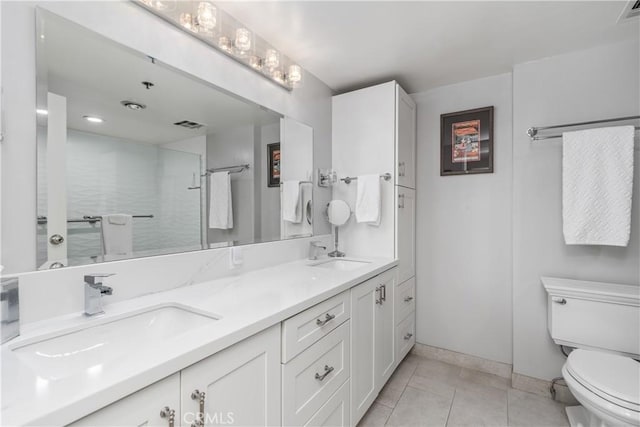 bathroom featuring toilet, tile patterned floors, and vanity