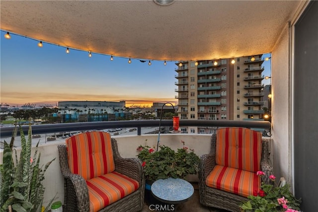 view of balcony at dusk