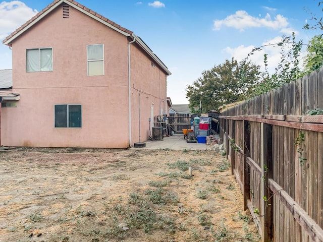 view of side of home featuring cooling unit and a patio