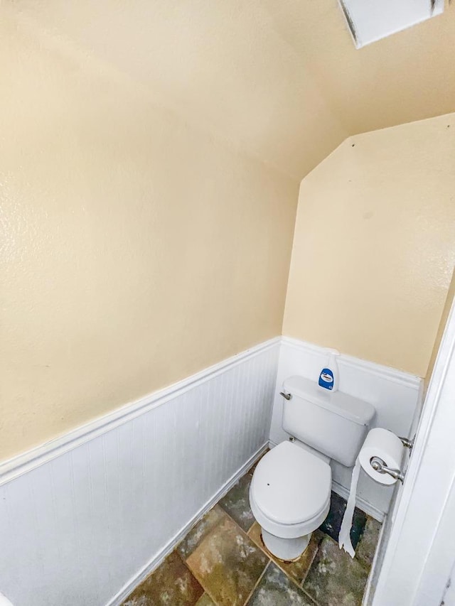 bathroom with vaulted ceiling and toilet