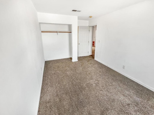 unfurnished bedroom with carpet floors and a closet