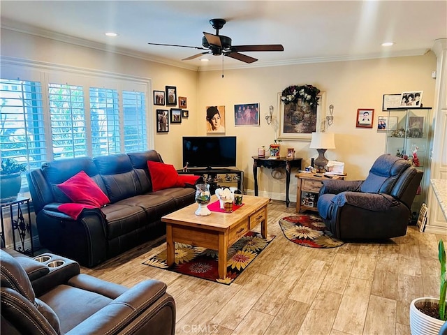 living room with ornamental molding, light wood-type flooring, baseboards, and a ceiling fan