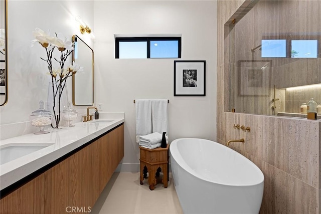 bathroom with vanity and independent shower and bath