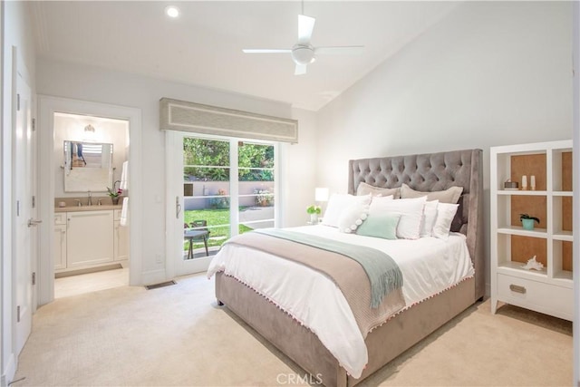 carpeted bedroom with lofted ceiling, ensuite bath, access to exterior, sink, and ceiling fan