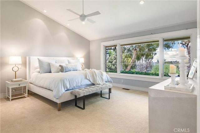 bedroom featuring ceiling fan, vaulted ceiling, and light carpet