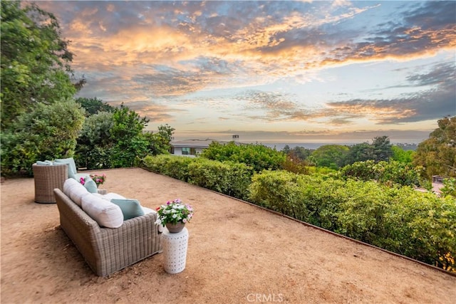 yard at dusk featuring a patio