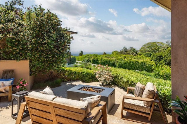 view of patio featuring an outdoor living space with a fire pit