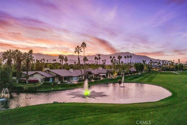 view of property's community featuring a mountain view and a lawn