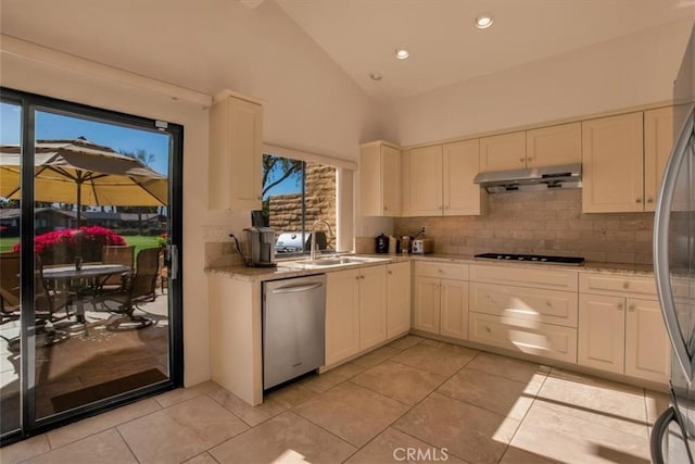 kitchen featuring light tile patterned flooring, high vaulted ceiling, sink, backsplash, and stainless steel appliances