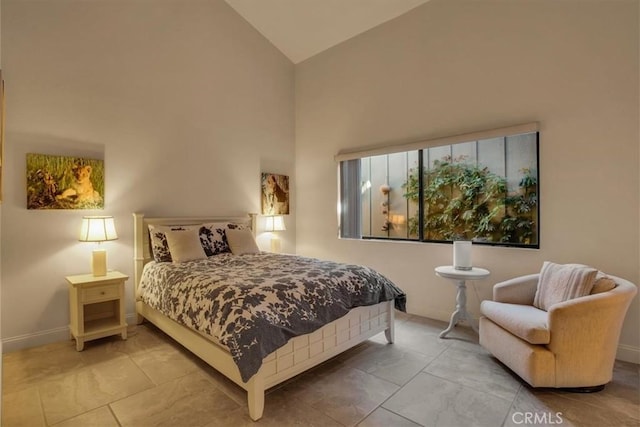 bedroom with high vaulted ceiling