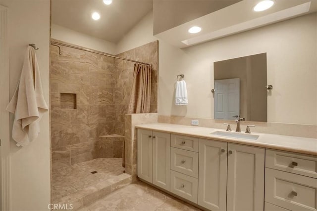 bathroom with a shower with curtain, vanity, and vaulted ceiling