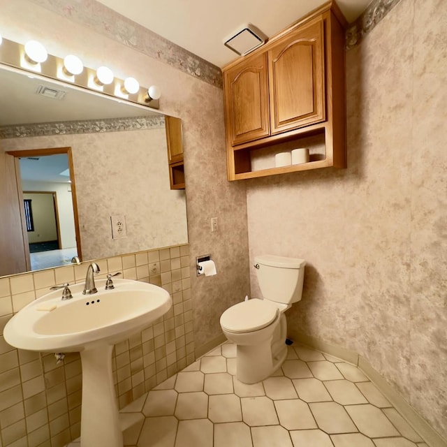 bathroom with toilet and tile patterned flooring