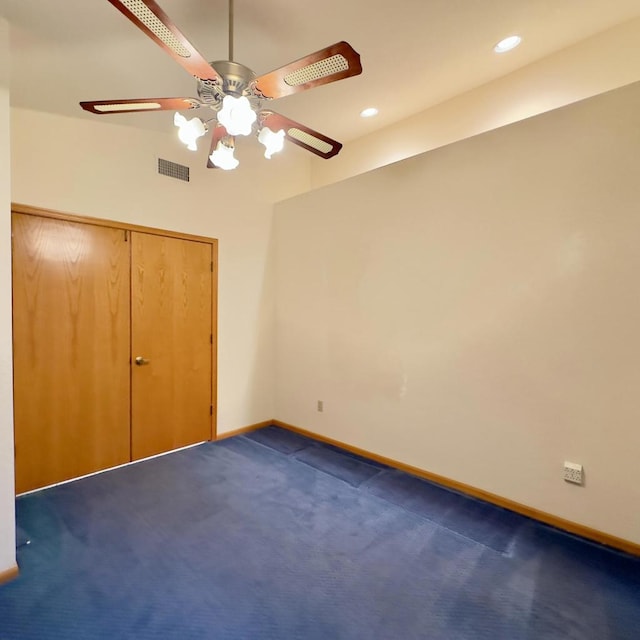 unfurnished bedroom featuring ceiling fan, a closet, and dark carpet