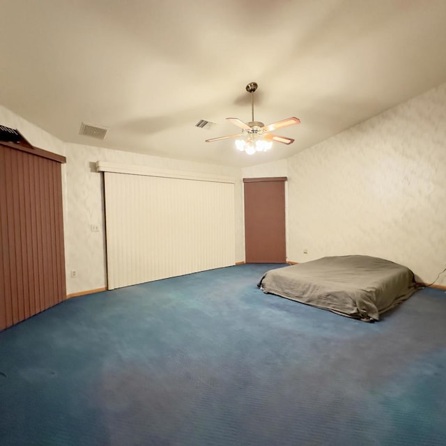 unfurnished bedroom with ceiling fan and carpet flooring