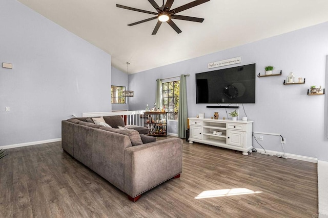 living room with dark wood-type flooring, vaulted ceiling, and ceiling fan