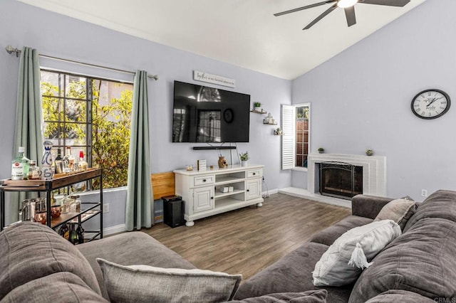 living room featuring dark hardwood / wood-style flooring, vaulted ceiling, and ceiling fan