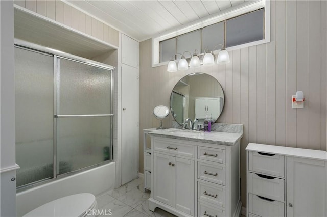 full bath with vanity, toilet, marble finish floor, and bath / shower combo with glass door