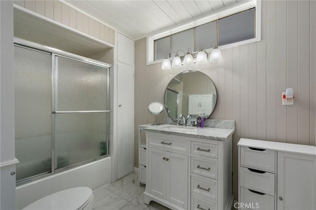 24B Surfside Ave, Surfside, CA 90743 - bathroom featuring marble look tile flooring, enclosed tub / shower combo, vanity, wooden walls, and toilet