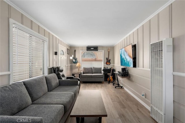24B Surfside Ave, Surfside, CA 90743 - living area featuring a heating unit, a decorative wall, wood finished floors, and ornamental molding