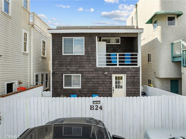 exterior space with a balcony and fence