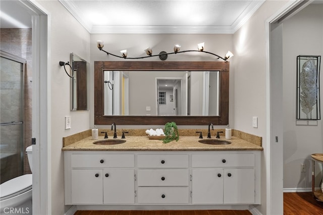 bathroom featuring an enclosed shower, vanity, toilet, hardwood / wood-style flooring, and crown molding