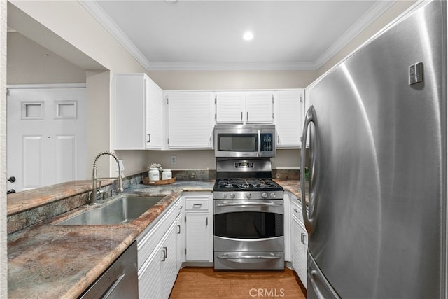 kitchen featuring white cabinets, sink, dark stone countertops, and stainless steel appliances