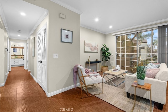 living area featuring crown molding and hardwood / wood-style flooring