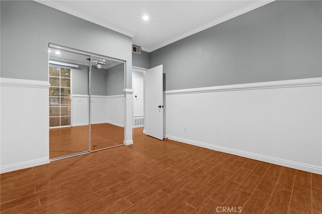 unfurnished bedroom with a closet and ornamental molding