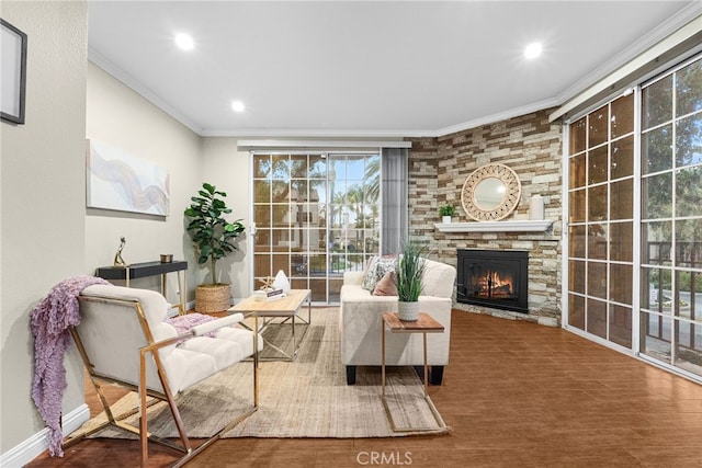 interior space featuring hardwood / wood-style floors, crown molding, and a stone fireplace