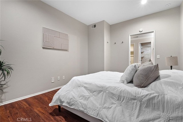 bedroom with dark wood-type flooring