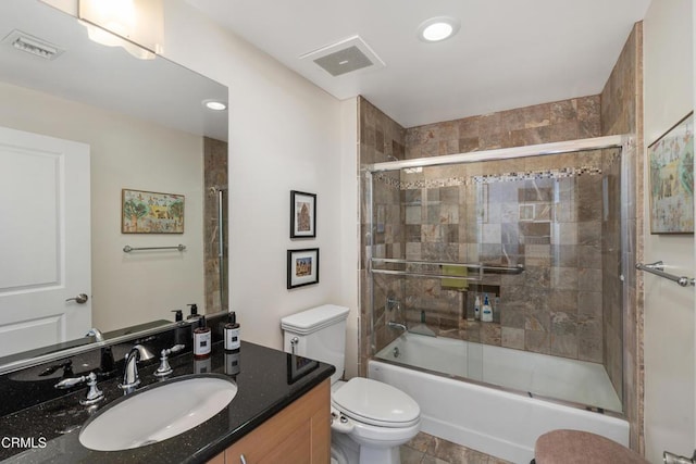 full bathroom with vanity, toilet, and combined bath / shower with glass door