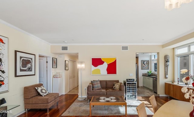 living room featuring wood-type flooring, ornamental molding, and beverage cooler