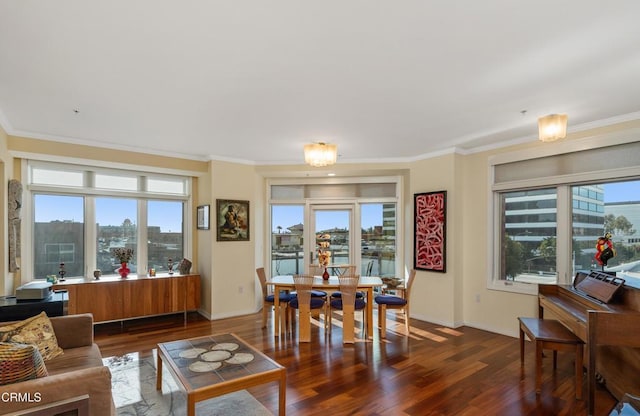 living room featuring ornamental molding, plenty of natural light, and dark hardwood / wood-style flooring