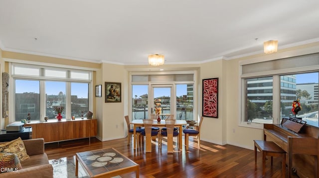 dining space featuring ornamental molding and dark hardwood / wood-style flooring