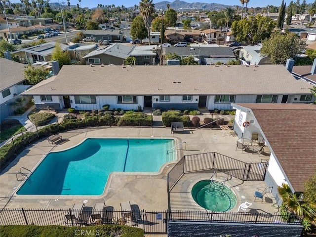 view of pool with a hot tub and a patio