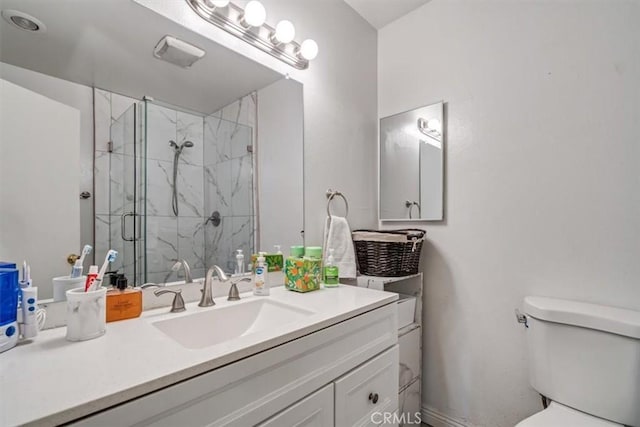 bathroom featuring vanity, toilet, and a shower with door