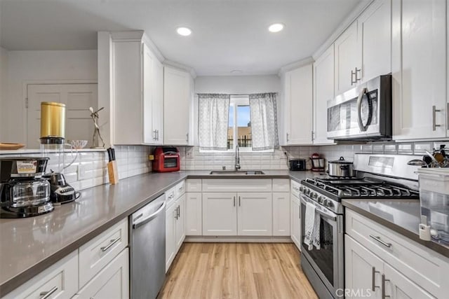 kitchen with stainless steel appliances and white cabinetry