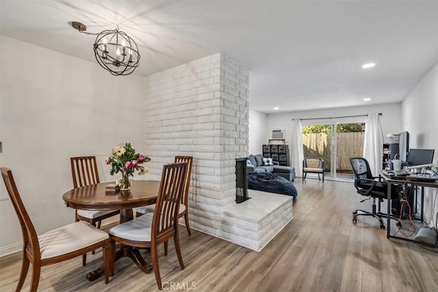 dining room featuring an inviting chandelier and hardwood / wood-style flooring